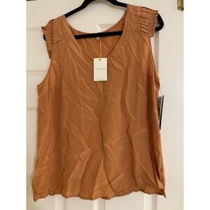 Skies are blue sleeveless gold top size large NWT